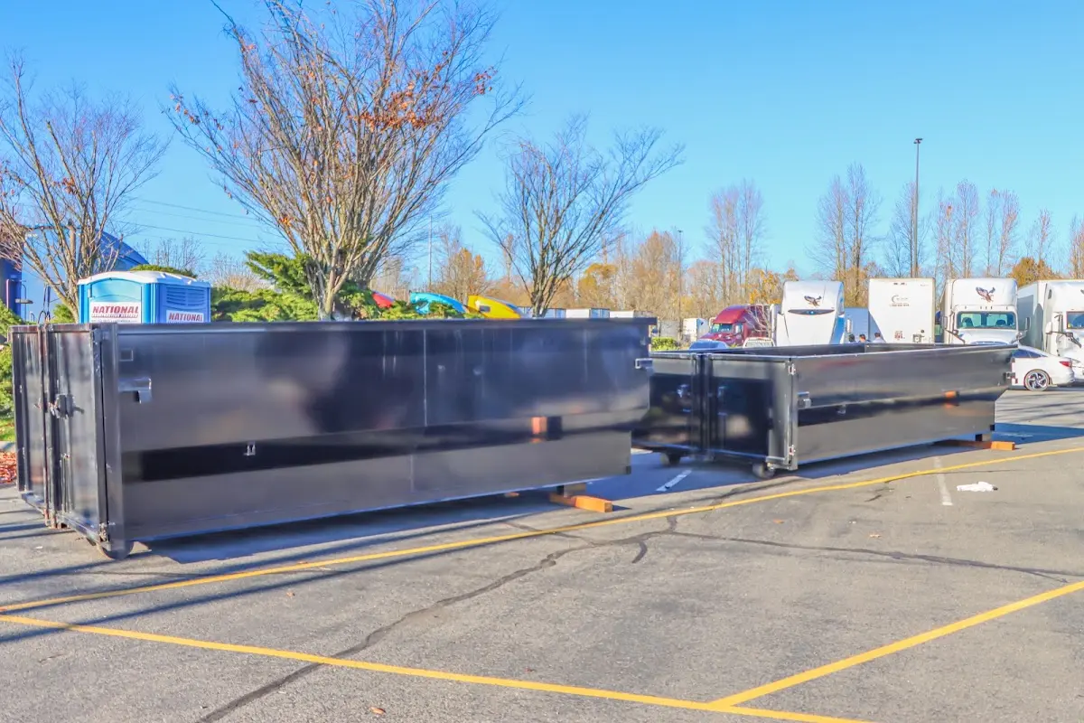 Professional dumpster rental service with roll-off container on residential driveway in Lincoln